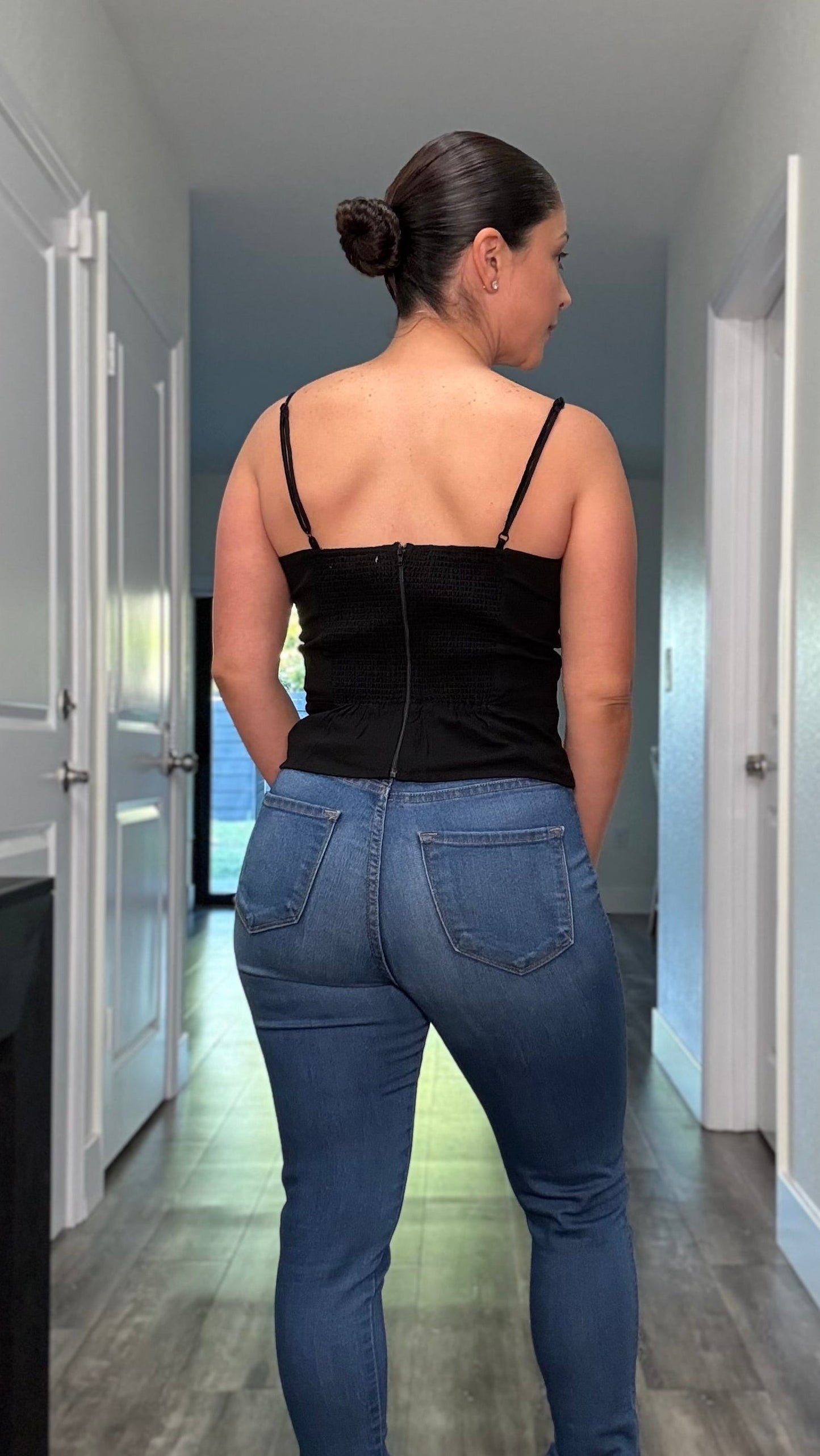 back side of black spaghetti strap shirt with zipper closure