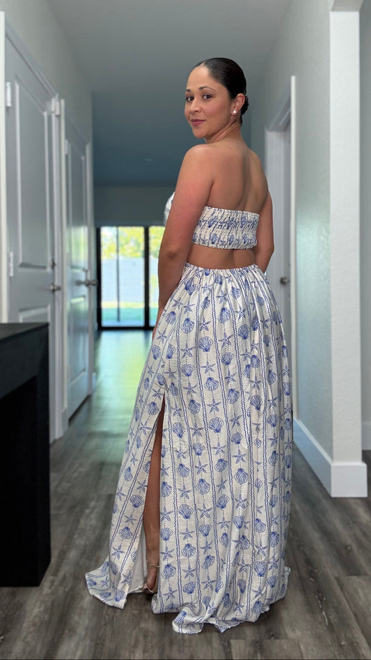white maxi dress with blue seashells and open back and side slits