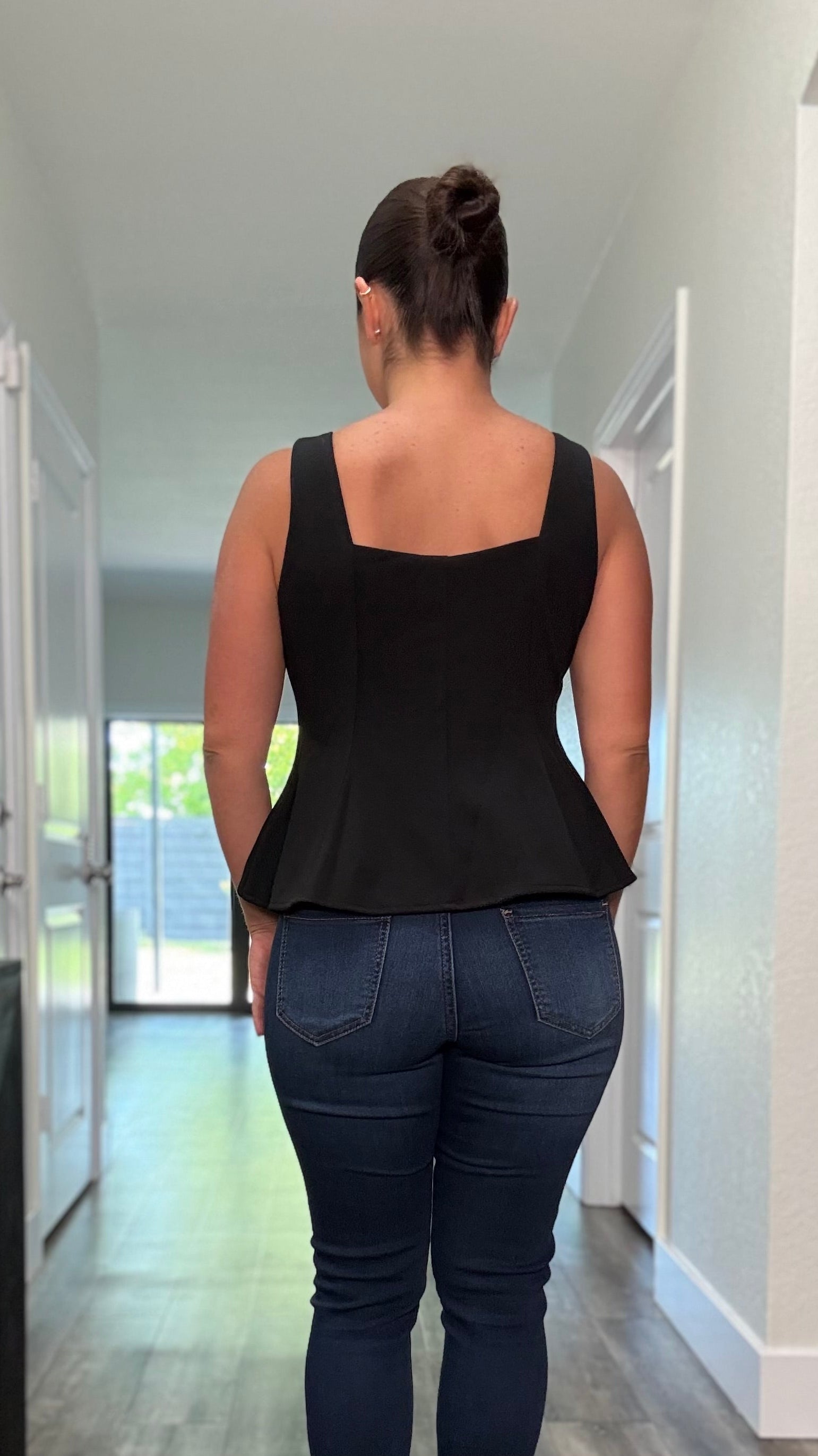 The back of the woman wearing a black flare top