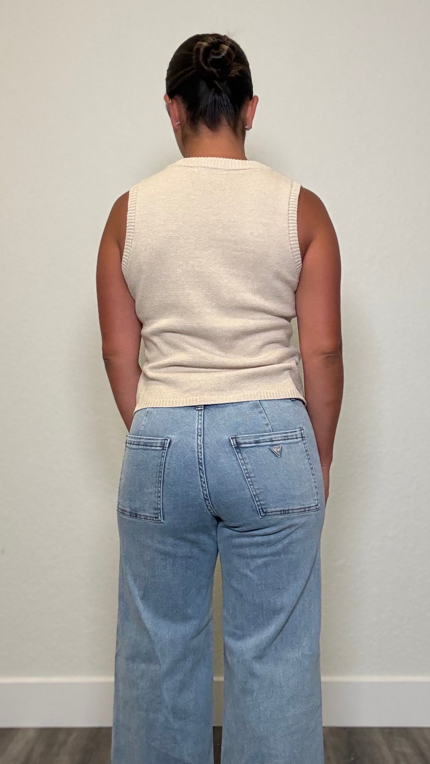 Woman wearing a beige knit top