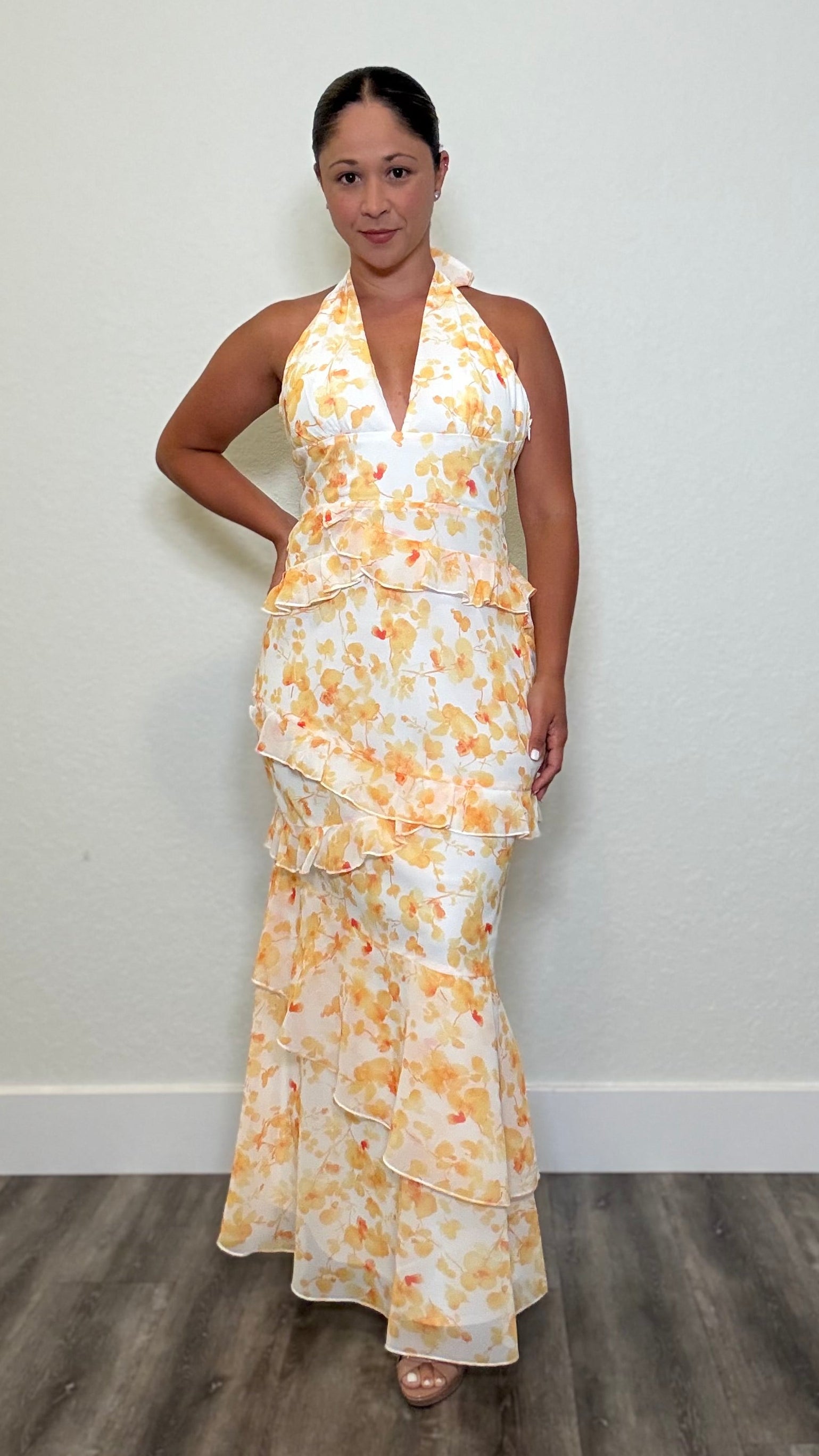 Woman wearing a a white with yellow floral maxi dress
