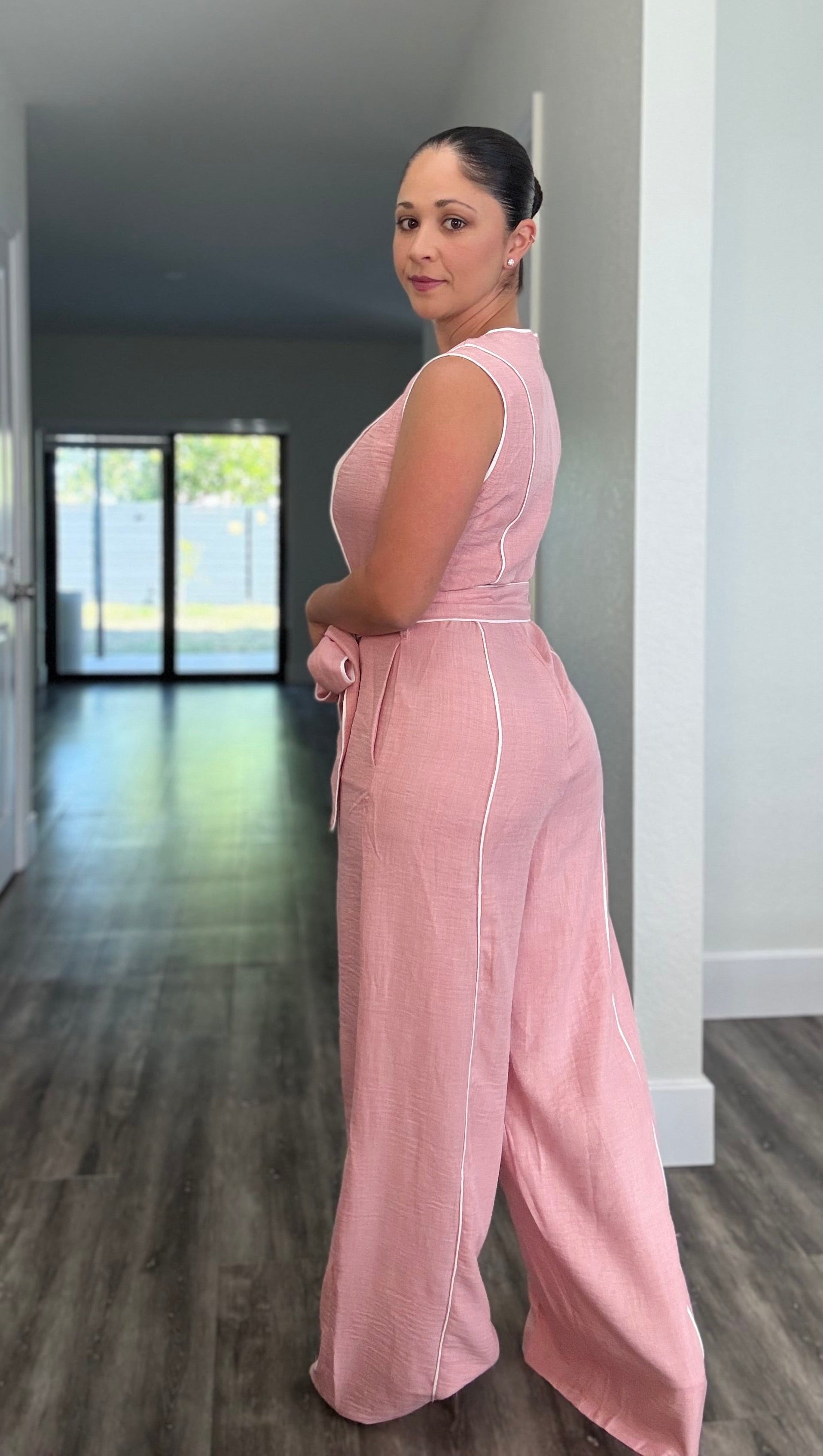 back side of pink jumpsuit with waist tie